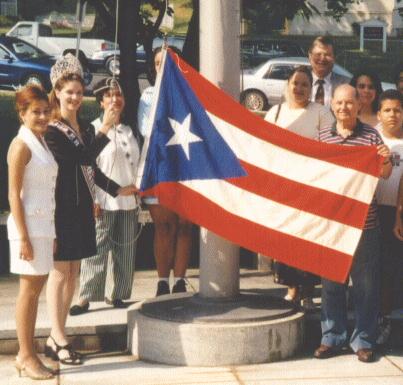 [Amy raises flag of Puerto Rico]